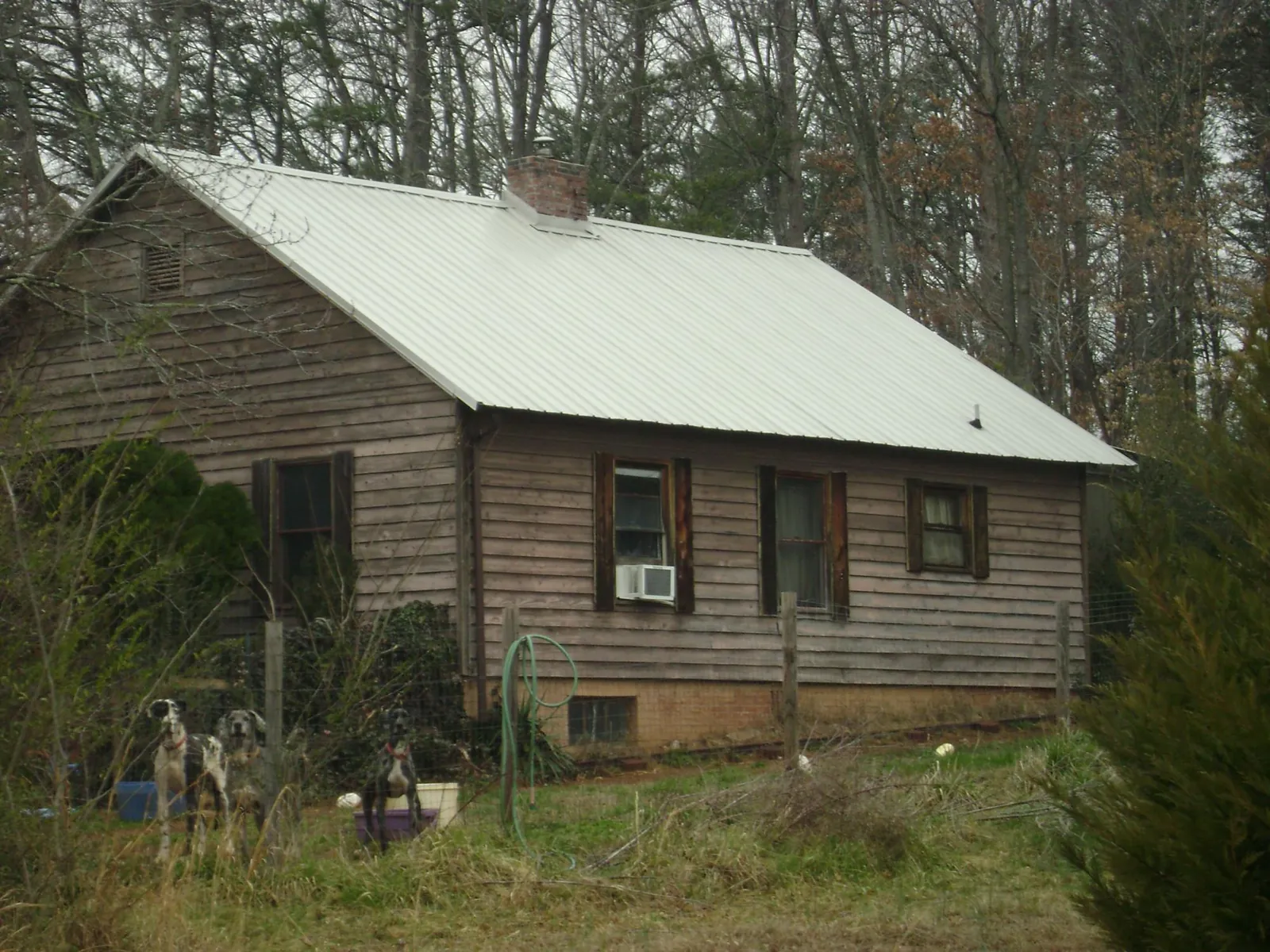 White metal roof on an old wood sided farmhouse, from a Asphalt Shingle Roof Repair job in Harford